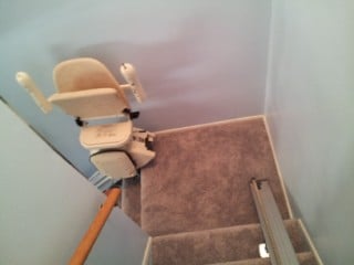 Two stairlifts on a split landing staircase